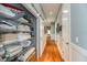 Hallway with a sliding closet, hardwood flooring, and traditional wainscoting at 2115 W Pipkin Rd, Lakeland, FL 33811