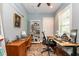 Bright home office featuring built-in bookcase, neutral paint, ceiling fan, and wood flooring at 2115 W Pipkin Rd, Lakeland, FL 33811
