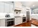 Chef's kitchen with stainless appliances, double ovens, gas range, and white cabinets, perfect for entertaining at 2115 W Pipkin Rd, Lakeland, FL 33811