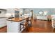 Open kitchen features a spacious island, stainless appliances, and counter seating for casual dining and entertaining at 2115 W Pipkin Rd, Lakeland, FL 33811