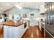 Spacious kitchen features white cabinetry, stainless steel appliances, and wood flooring at 2115 W Pipkin Rd, Lakeland, FL 33811