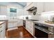 Gourmet kitchen features white cabinets, subway tile backsplash, stainless steel appliances, and marble countertops at 2115 W Pipkin Rd, Lakeland, FL 33811