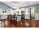 Gourmet kitchen features custom white cabinets, stainless steel appliances, central island, and sleek lighting at 2115 W Pipkin Rd, Lakeland, FL 33811