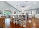 Bright kitchen and dining area with hardwood floors, white cabinets, stainless appliances, and a vaulted ceiling at 2115 W Pipkin Rd, Lakeland, FL 33811