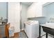 Well-organized laundry room with modern appliances, ample cabinet space, and a utility sink at 2115 W Pipkin Rd, Lakeland, FL 33811