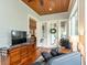 Comfortable living room with a fireplace, sunroom access, and entertainment setup for relaxation at 2115 W Pipkin Rd, Lakeland, FL 33811