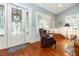 Sitting area with hardwood floors, a large window, and a decorative front door, creating a welcoming space at 2115 W Pipkin Rd, Lakeland, FL 33811