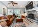Living room with a stone fireplace, hardwood floors, an area rug, and a clear view of the decorative front door at 2115 W Pipkin Rd, Lakeland, FL 33811