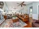 Open-concept living room featuring a fireplace, vaulted ceilings, and a seamless transition to the kitchen at 2115 W Pipkin Rd, Lakeland, FL 33811