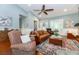 Comfortable living room with a fireplace, hardwood floors, and ample seating, perfect for relaxation and entertaining at 2115 W Pipkin Rd, Lakeland, FL 33811