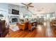 Spacious living room with a stone fireplace, hardwood floors, and an open layout to the kitchen at 2115 W Pipkin Rd, Lakeland, FL 33811