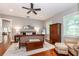 Well lit main bedroom with a ceiling fan, wood flooring, and ensuite bathroom at 2115 W Pipkin Rd, Lakeland, FL 33811