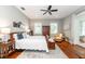 Spacious main bedroom with a ceiling fan, wood flooring, and ensuite at 2115 W Pipkin Rd, Lakeland, FL 33811