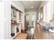 Bright pantry featuring open shelving, workspace, and adjacent access to laundry and outdoor spaces at 2115 W Pipkin Rd, Lakeland, FL 33811