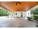 Spacious outdoor patio features wood ceiling, ceiling fans, and ample space for entertaining guests at 2115 W Pipkin Rd, Lakeland, FL 33811