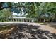 Large property with multiple outbuildings, a sprawling lawn, and mature trees at 2115 W Pipkin Rd, Lakeland, FL 33811
