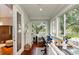 Bright sun room with wood flooring and multiple windows overlooking the backyard at 2115 W Pipkin Rd, Lakeland, FL 33811