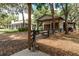 Exterior view of a fenced yard, showing the main house and outbuildings at 2115 W Pipkin Rd, Lakeland, FL 33811