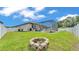 The backyard features a fire pit and screened-in patio, providing a space for outdoor gatherings at 2277 Bella Luna Cir, Lakeland, FL 33810
