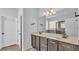 Bright bathroom featuring double vanity, modern fixtures, walk-in shower, and tiled floors at 2277 Bella Luna Cir, Lakeland, FL 33810