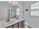 Bathroom featuring double sinks, a large mirror, and a window at 2277 Bella Luna Cir, Lakeland, FL 33810
