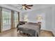 Relaxing bedroom with tray ceiling, ceiling fan, and curtains that enhance the natural light at 2277 Bella Luna Cir, Lakeland, FL 33810