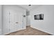 Neutral bedroom featuring wood-look tile floors, closet, and mounted TV at 2277 Bella Luna Cir, Lakeland, FL 33810