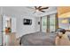 Spacious bedroom with tray ceiling, ceiling fan, and en-suite bathroom, offering a peaceful retreat at 2277 Bella Luna Cir, Lakeland, FL 33810