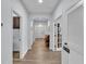 Spacious hallway with wood-look tile floors, arched doorways, and neutral paint at 2277 Bella Luna Cir, Lakeland, FL 33810