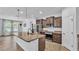 Bright kitchen featuring granite countertops, stainless steel appliances, and dark wood cabinets at 2277 Bella Luna Cir, Lakeland, FL 33810