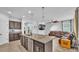 Open kitchen view featuring granite island, stainless appliances and connected living area at 2277 Bella Luna Cir, Lakeland, FL 33810