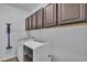 Laundry room featuring upper cabinets, washer, and dryer with light blue walls at 2277 Bella Luna Cir, Lakeland, FL 33810