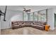 Inviting living room featuring a large brown leather sectional, modern lighting, and neutral decor at 2277 Bella Luna Cir, Lakeland, FL 33810