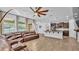 Open-concept living space showcasing a comfortable leather sofa, a modern kitchen, and tile flooring at 2277 Bella Luna Cir, Lakeland, FL 33810