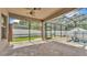 Covered patio with brick pavers, screening, and an open view to the backyard and swimming pool at 2277 Bella Luna Cir, Lakeland, FL 33810