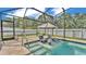 Inviting swimming pool with built-in lounge chairs, an umbrella, and a screened enclosure at 2277 Bella Luna Cir, Lakeland, FL 33810
