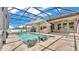 Beautiful swimming pool featuring an umbrella, built-in lounge chairs, and a screened enclosure at 2277 Bella Luna Cir, Lakeland, FL 33810