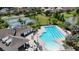 Aerial shot of community pool, tennis courts, and clubhouse, all landscaped with lush greenery at 2468 Winnipeg Dr, Lakeland, FL 33805