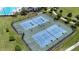Aerial view showcasing outdoor tennis courts with professional lighting for evening matches at 2468 Winnipeg Dr, Lakeland, FL 33805