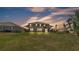 Beautiful large backyard with a screened-in patio, swing set, and well-maintained green lawn at 2468 Winnipeg Dr, Lakeland, FL 33805