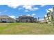 Spacious backyard with screened-in lanai and swing set, ideal for outdoor living at 2468 Winnipeg Dr, Lakeland, FL 33805