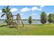 Picturesque backyard with wooden swing overlooking a serene lake view at 2468 Winnipeg Dr, Lakeland, FL 33805