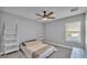 A simple bedroom design with lots of space and natural light and a ceiling fan at 2468 Winnipeg Dr, Lakeland, FL 33805