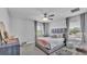 Cozy bedroom showcases a comfortable bed, ceiling fan, windows with light-filtering blinds and neutral decor at 2468 Winnipeg Dr, Lakeland, FL 33805