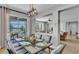 The dining room features a modern light fixture, seating for six, and sliding glass doors leading to the screened-in patio and lake view at 2468 Winnipeg Dr, Lakeland, FL 33805