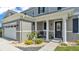 Charming front entrance featuring columns, a decorative door, and a well-manicured garden at 2468 Winnipeg Dr, Lakeland, FL 33805