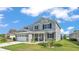 Charming exterior of a two-story home featuring a two-car garage, well-maintained lawn, and a welcoming porch at 2468 Winnipeg Dr, Lakeland, FL 33805