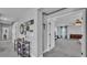 Hallway with decorative wall art leading to a bedroom with blue curtains at 2468 Winnipeg Dr, Lakeland, FL 33805