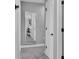 Hallway with gray walls and a tall mirror reflecting the interior of the home at 2468 Winnipeg Dr, Lakeland, FL 33805