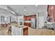 Spacious kitchen features an island with granite countertops, dark cabinets, and stainless appliances at 2468 Winnipeg Dr, Lakeland, FL 33805